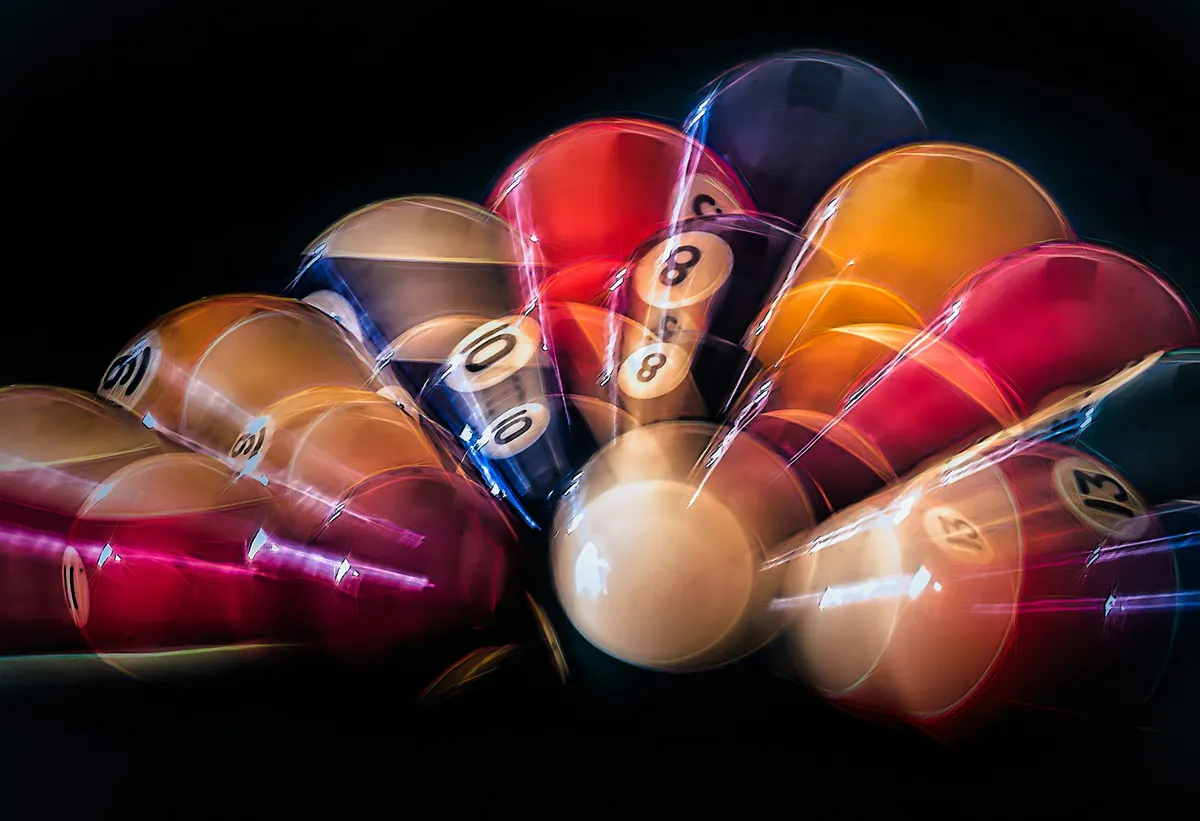 Colourful pool balls captured in motion