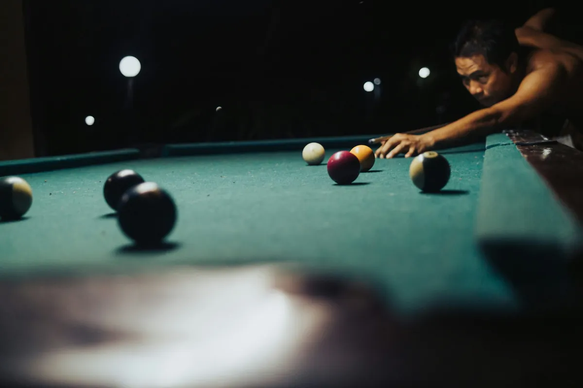 Pool player concentrating on a shot, from the Game On website collection